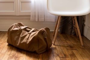 a bronw purse next to a chair