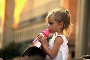 a young girl drinks water