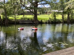 People tubing on calm river