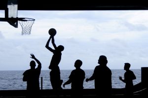 Silhouette image of people playing basketball