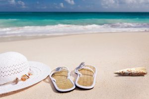 Hat and sandals on the beach