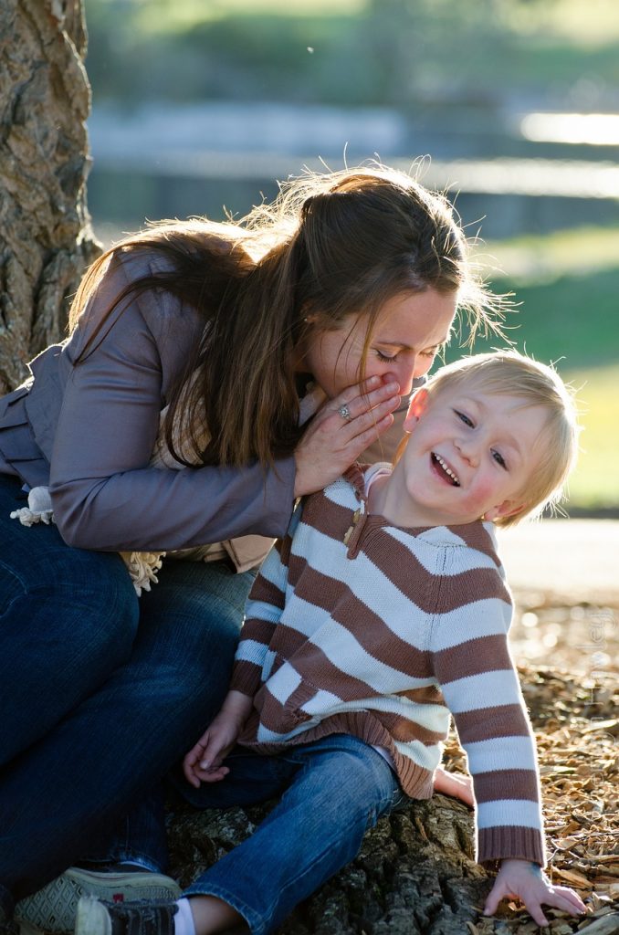 Parent whispering to child