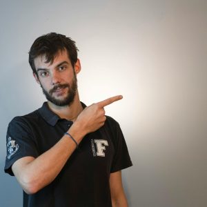 Young man pointing to side