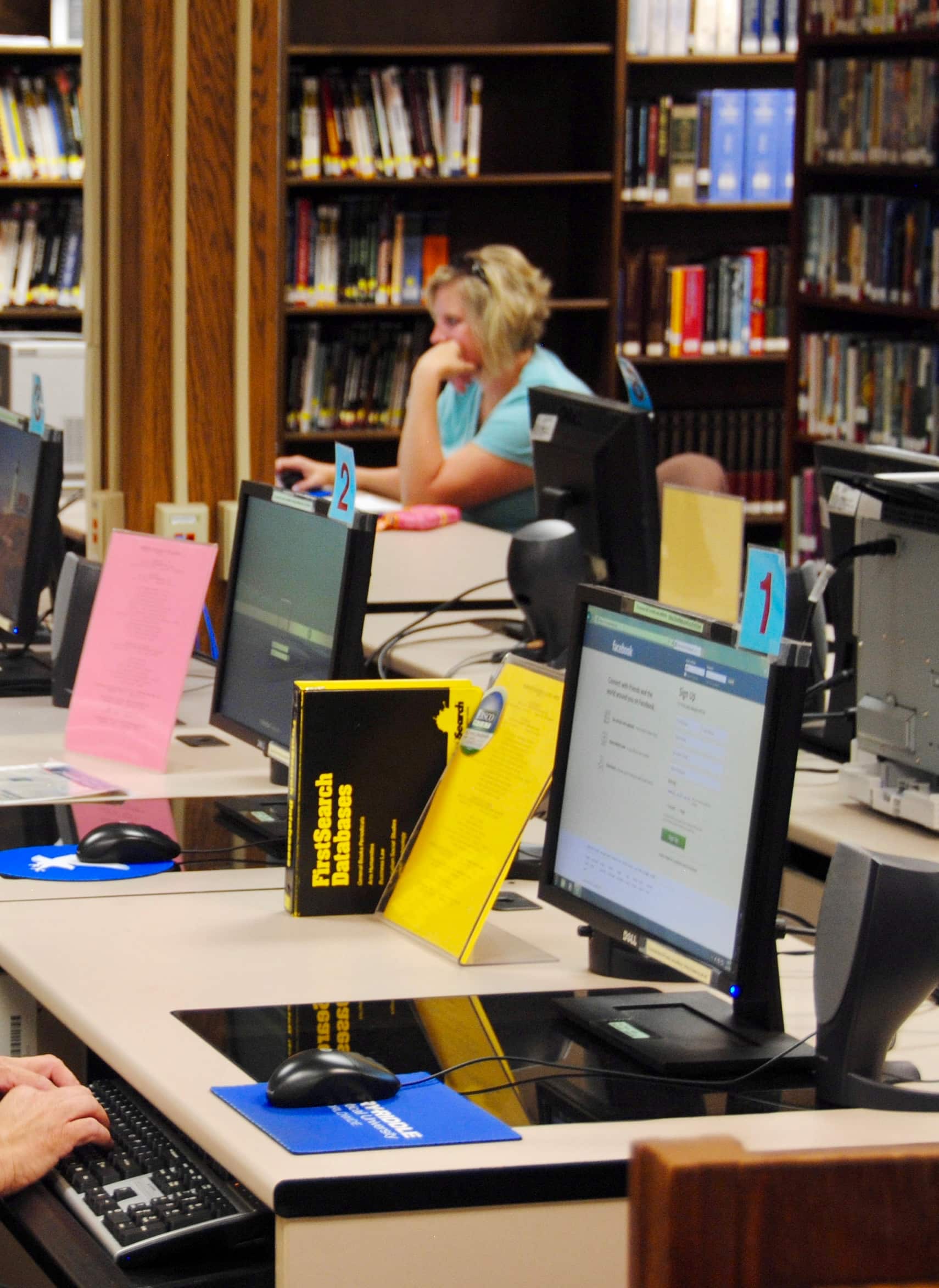 woman studying in a library with computers
