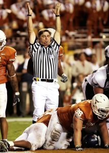UT football players with referee signaling touchdown